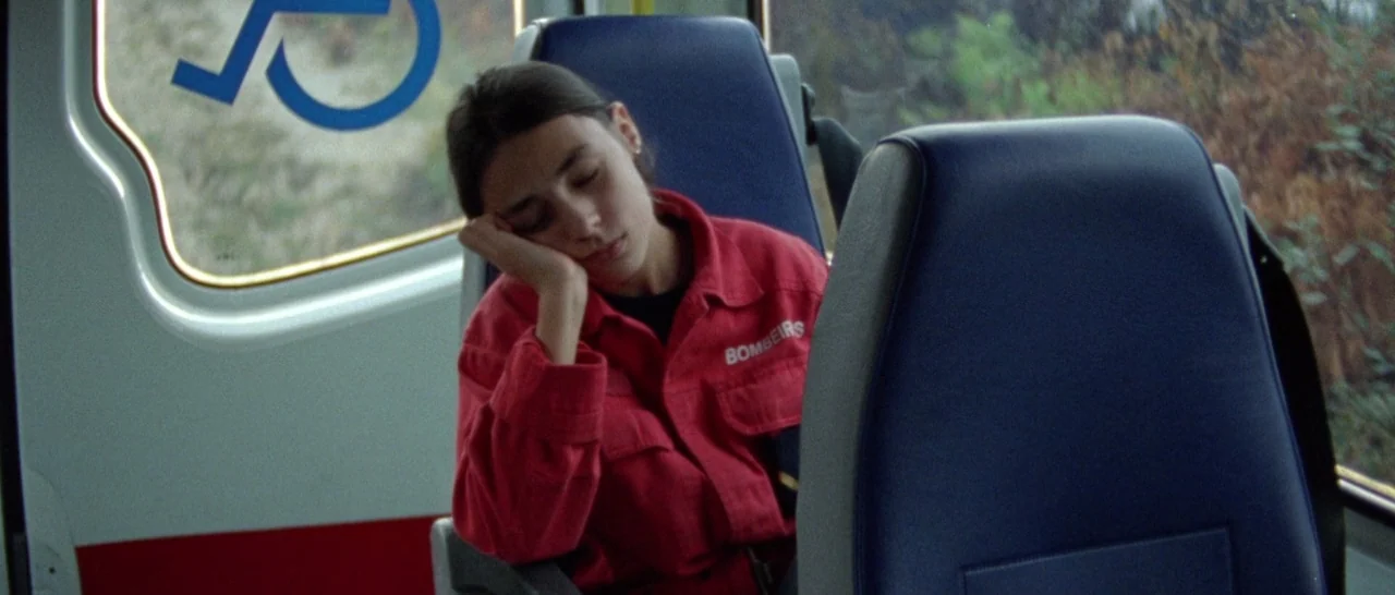 Arabian Nights: Volume 1 – The Restless One (2015) movie still: medium — A bus interior features blue vinyl seating with a blue accessibility icon…