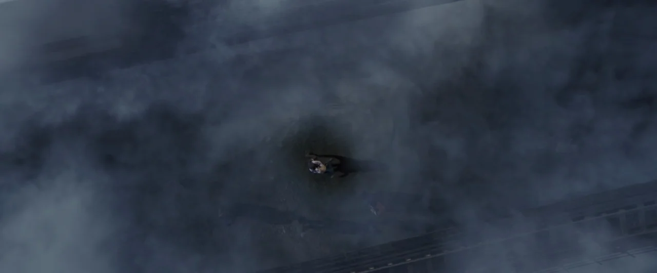 The Greatest Showman (2017) movie still: establishing — A dark, elevated railway track is heavily obscured by thick, billowing gray smoke. The train…