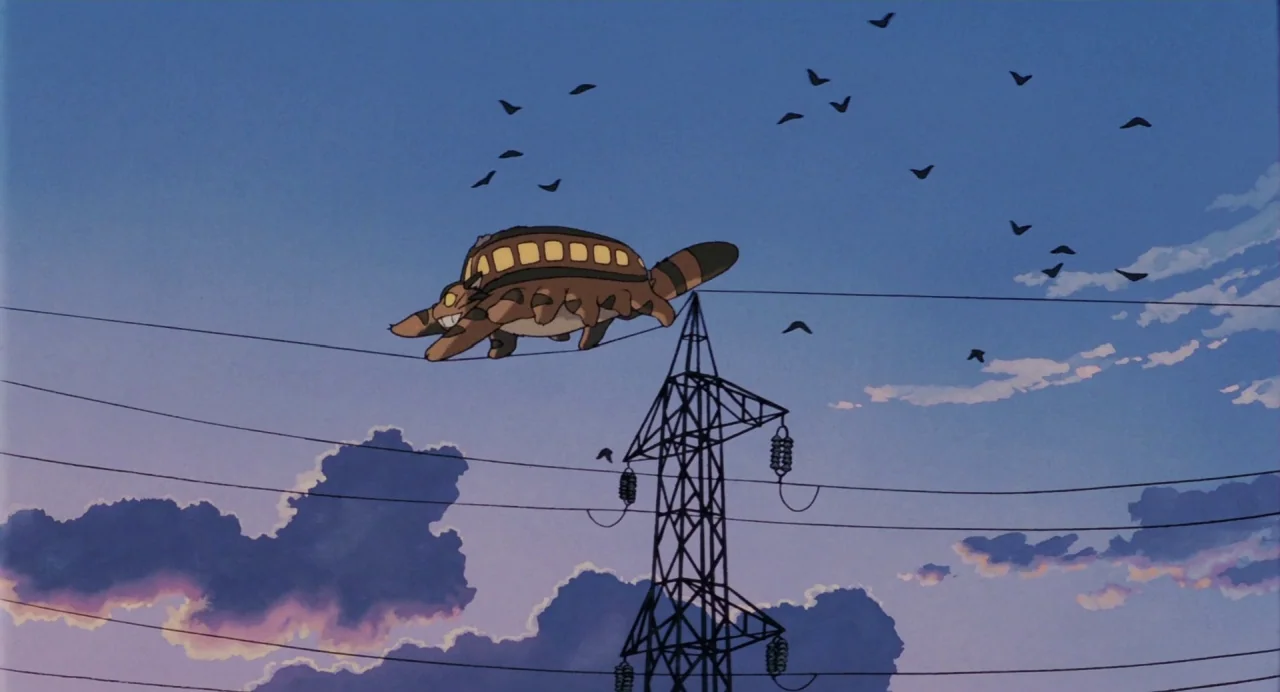 My Neighbour Totoro (1988) movie still: wide — A dusk sky is filled with clouds and a metal electricity transmission tower. A large, brown,…