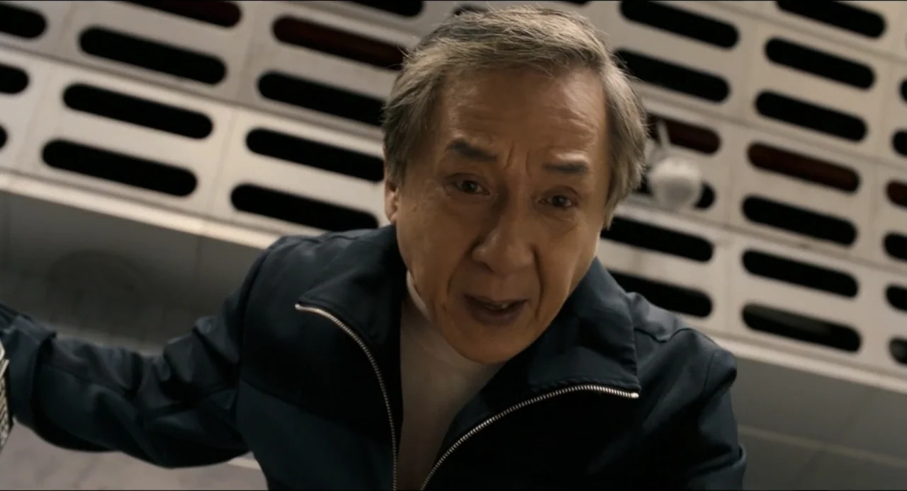 Karate Kid: Legends (2025) movie still: closeup — An interior hallway features white walls with repeated horizontal rectangular recessed panels.