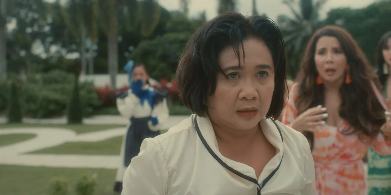 Ten Little Mistresses (2023) movie still: medium — A manicured outdoor courtyard with trees and paths serves as the setting. A woman in a white…