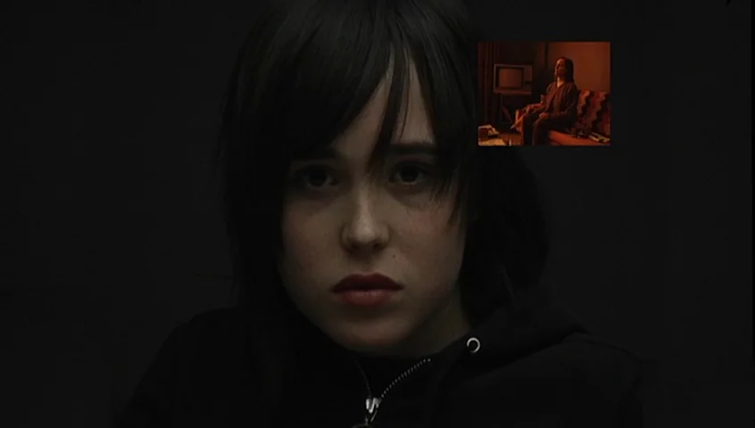 The Tracey Fragments (2007) movie still: closeup — A close-up shot focuses on a young person with dark hair against a black background. A small…