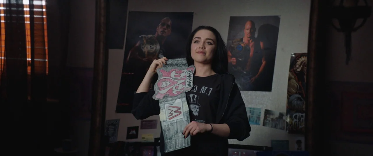 Fighting With My Family (2019) movie still: medium — A bedroom wall is decorated with posters of professional wrestlers like Stone Cold Steve…