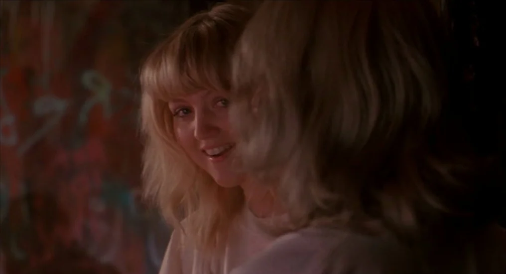A Nightmare On Elm Street 4: The Dream Master (1988) movie still: closeup — A dimly lit indoor space features textured, dark walls with…
