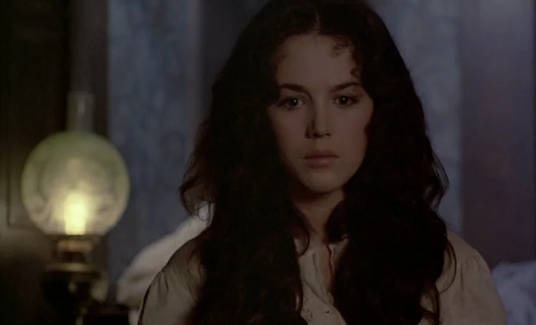 The Story of Adele H (1975) movie still: closeup — A dimly lit room contains a young woman near a glowing lamp. She sits motionless in the dark…