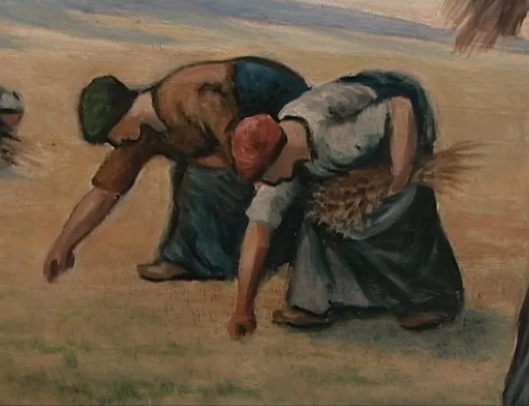 The Gleaners & I (2000) movie still: medium — A field of harvested wheat with visible dry stalks and stubble. Two women are bent over collecting…