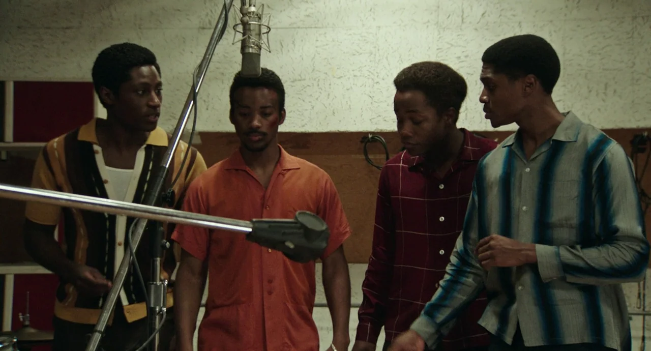 Detroit (2017) movie still: medium — A low-ceilinged studio space features acoustic foam panels and professional audio equipment. Four young men in…