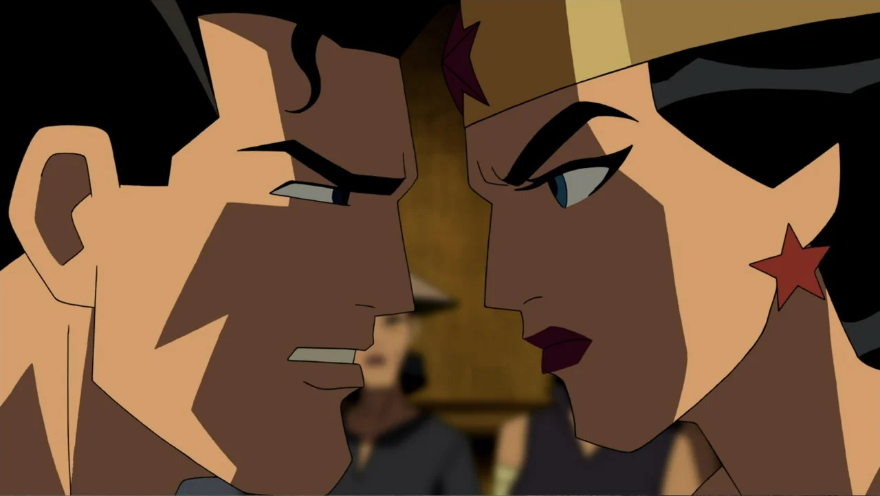Justice League: The New Frontier (2008) movie still: closeup — A dimly lit indoor space with two figures standing close together. Superman and…