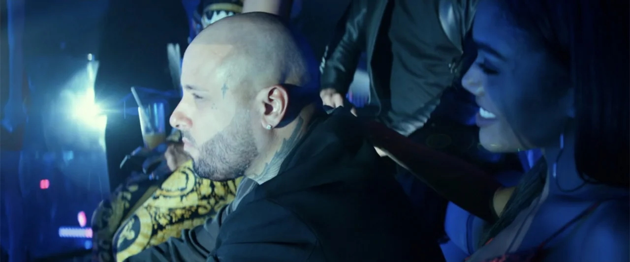 Bad Boys for Life (2020) movie still: medium — A dimly lit interior space with dense crowds and blue neon illumination. A bald man with facial…