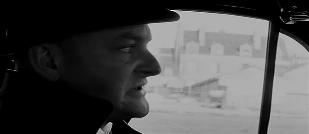 Shoot The Piano Player (Tirez Sur Le Pianiste) (1960) movie still: closeup — A view inside a vehicle with the side window revealing a blurred…