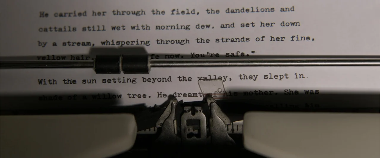 A Walk Among the Tombstones (2014) movie still: closeup — A close-up view of a typewriter carriage holding a sheet of white paper. The typed text is…