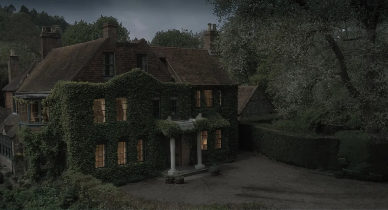 Death at a Funeral (2010) movie still: wide — A large multi-story manor house covered in dense ivy stands against a backdrop of trees. Several…