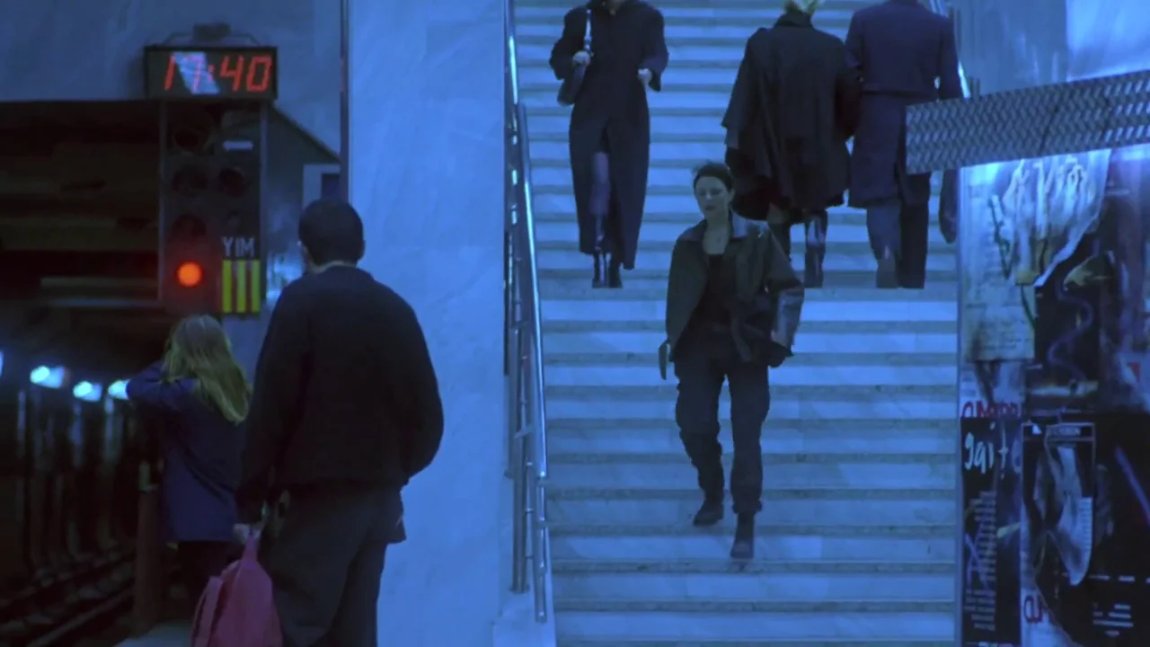 Hellraiser: Deader (2005) movie still: medium — An underground transit station with marble stairs and red neon digital signage. A woman descends the…