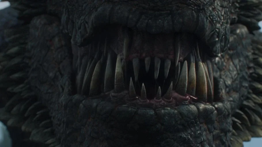 Game of Thrones (2017) movie still: closeup — A close-up of a dragon's open jaws revealing sharp, layered teeth and dark gums. The creature's scaly,…