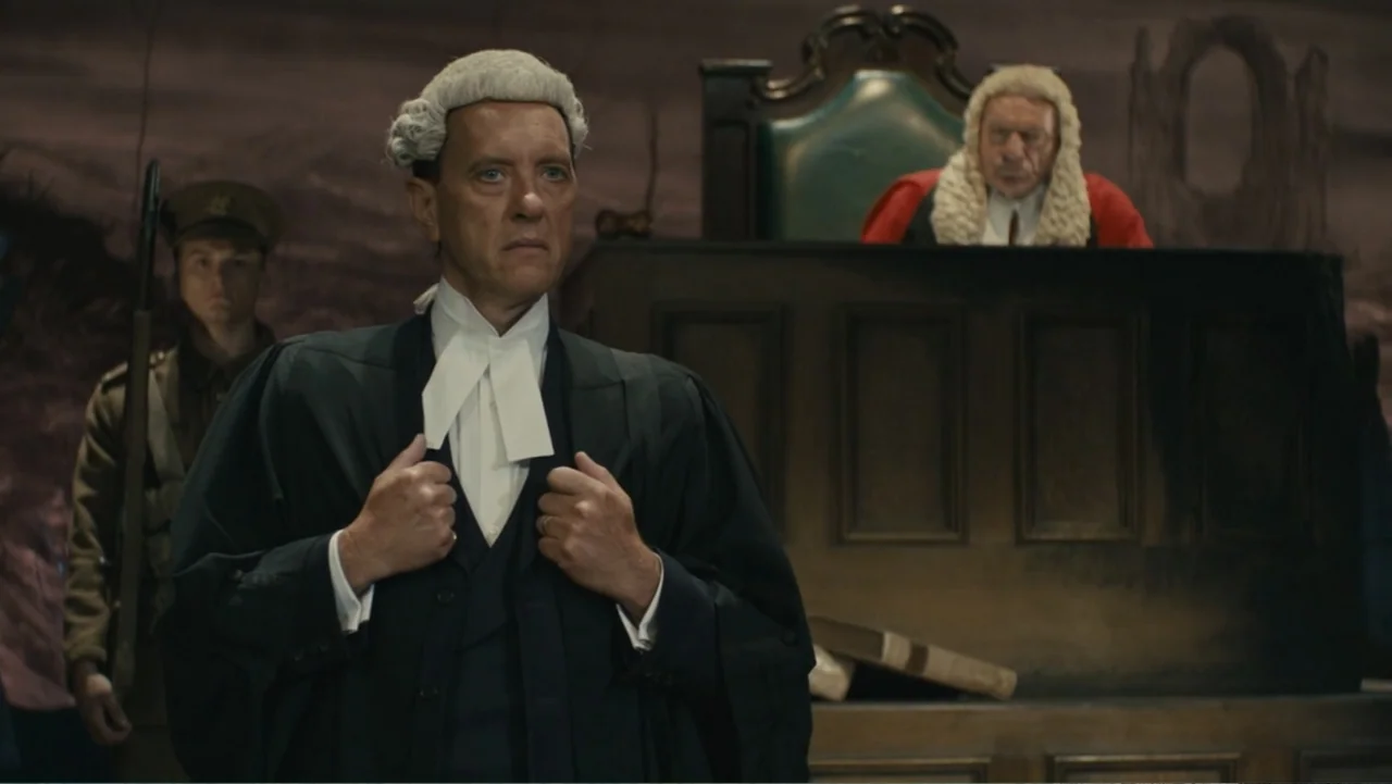 About Time (2013) movie still: medium — A dimly lit courtroom features a wooden bench and dark, textured walls. A barrister in formal robes stands…