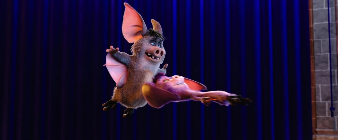 Happy Family (2018) movie still: fullbody — A theatrical stage with deep blue curtains provides the background for two animated bats. The two…