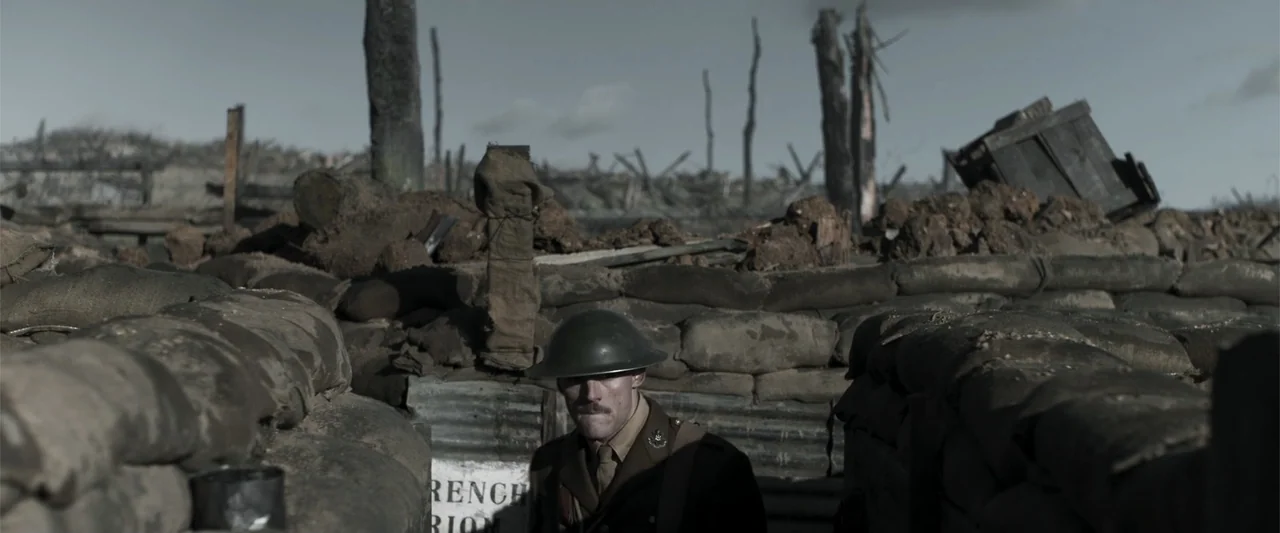 Gone Missing -  Old John's Final Journey (2014) movie still: medium — A World War I trench system features dirt mounds, sandbags, and scattered dead…