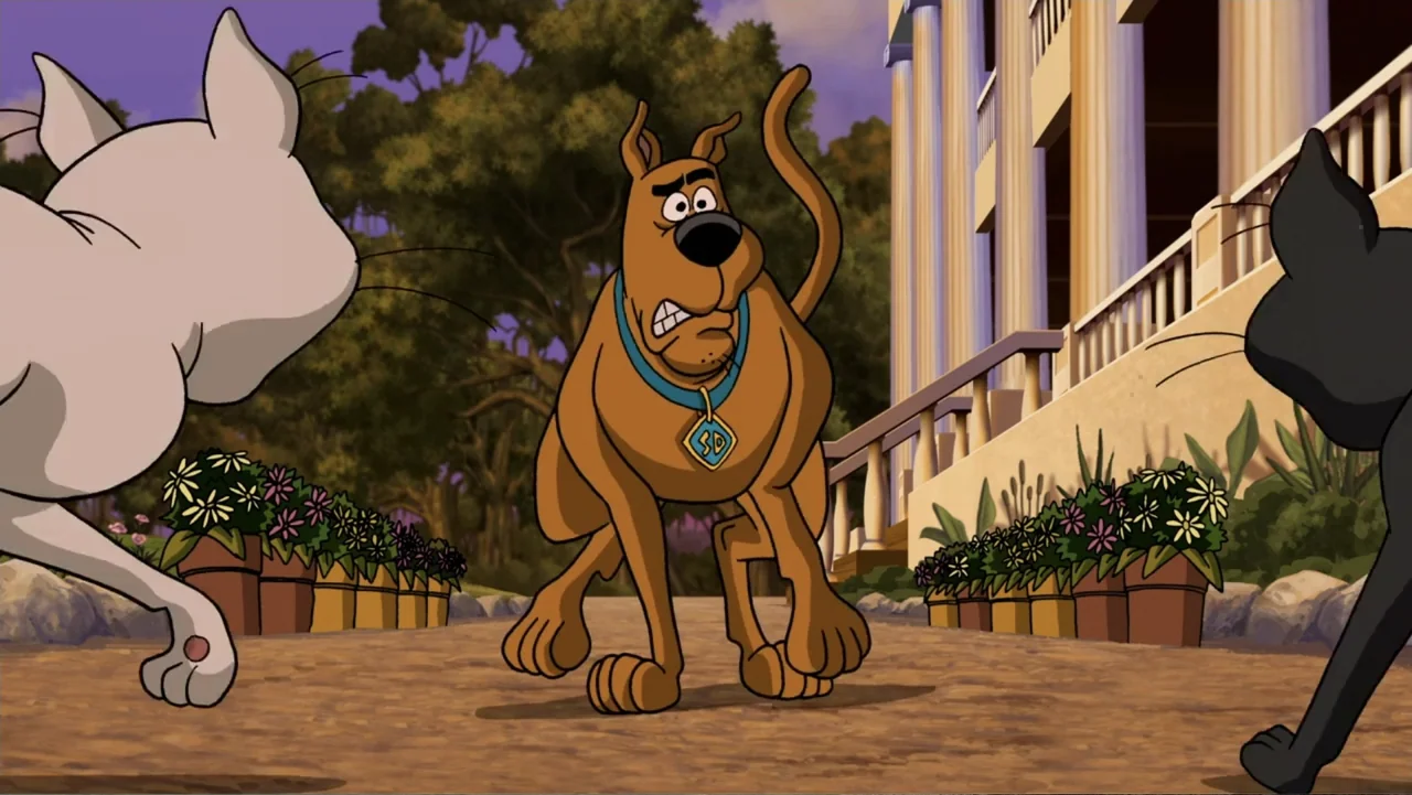 Scooby-Doo! Return to Zombie Island (2019) movie still: medium — A paved path leads to a large mansion with columns at twilight. Scooby-Doo stands…