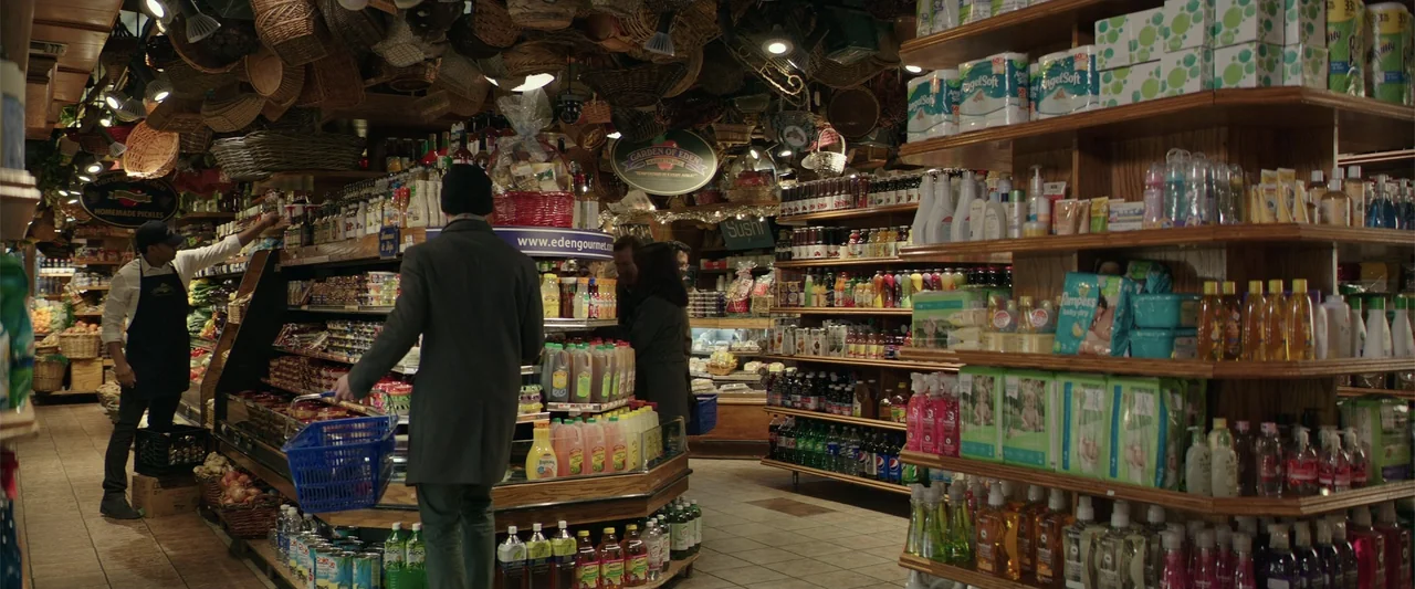 Collateral Beauty (2016) movie still: medium — A well-stocked grocery store features shelves packed with various consumer goods and groceries. A man…