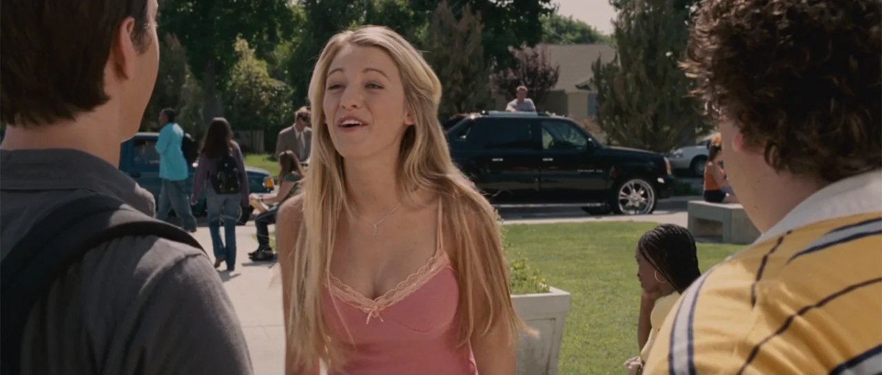 Accepted (2006) movie still: medium — An outdoor area with paved walkways and grass with students milling in the background. A young woman in a pink…