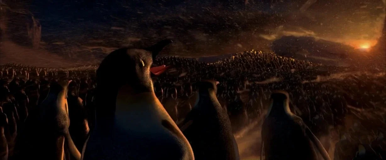 Happy Feet (2006) movie still: wide — A vast expanse of snow-covered plains in Antarctica during sunset with blowing ice particles. A massive colony…
