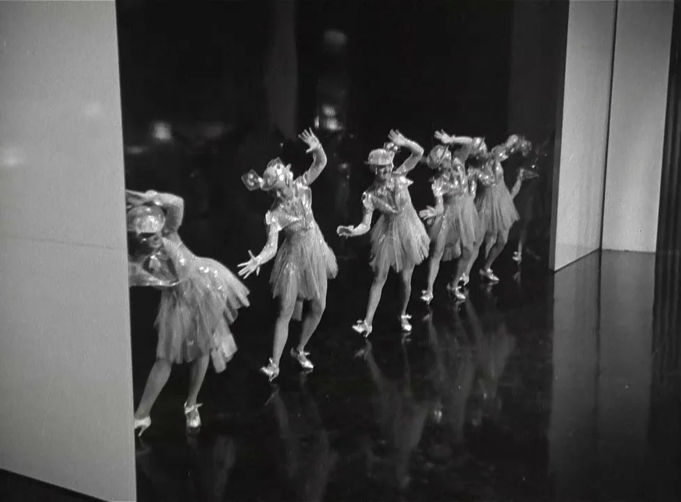 Swing Time (1936) movie still: fullbody — A polished dark stage with white geometric walls flanking the dancers. Five dancers perform a synchronized…
