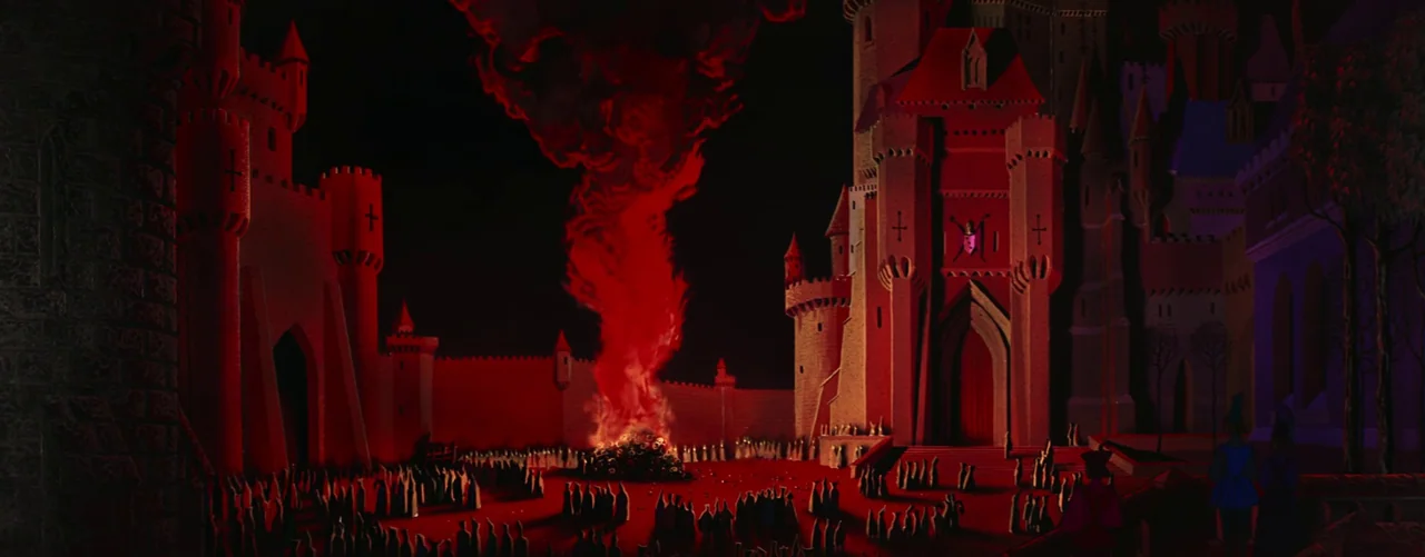 Sleeping Beauty (1959) movie still: wide — A large stone castle stands in a dark courtyard with a fire burning centrally. Many small silhouetted…