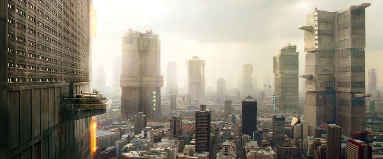 Dredd (2012) movie still: establishing — A vast futuristic megacity features massive, tall brutalist towers rising above a dense lower urban sprawl.…