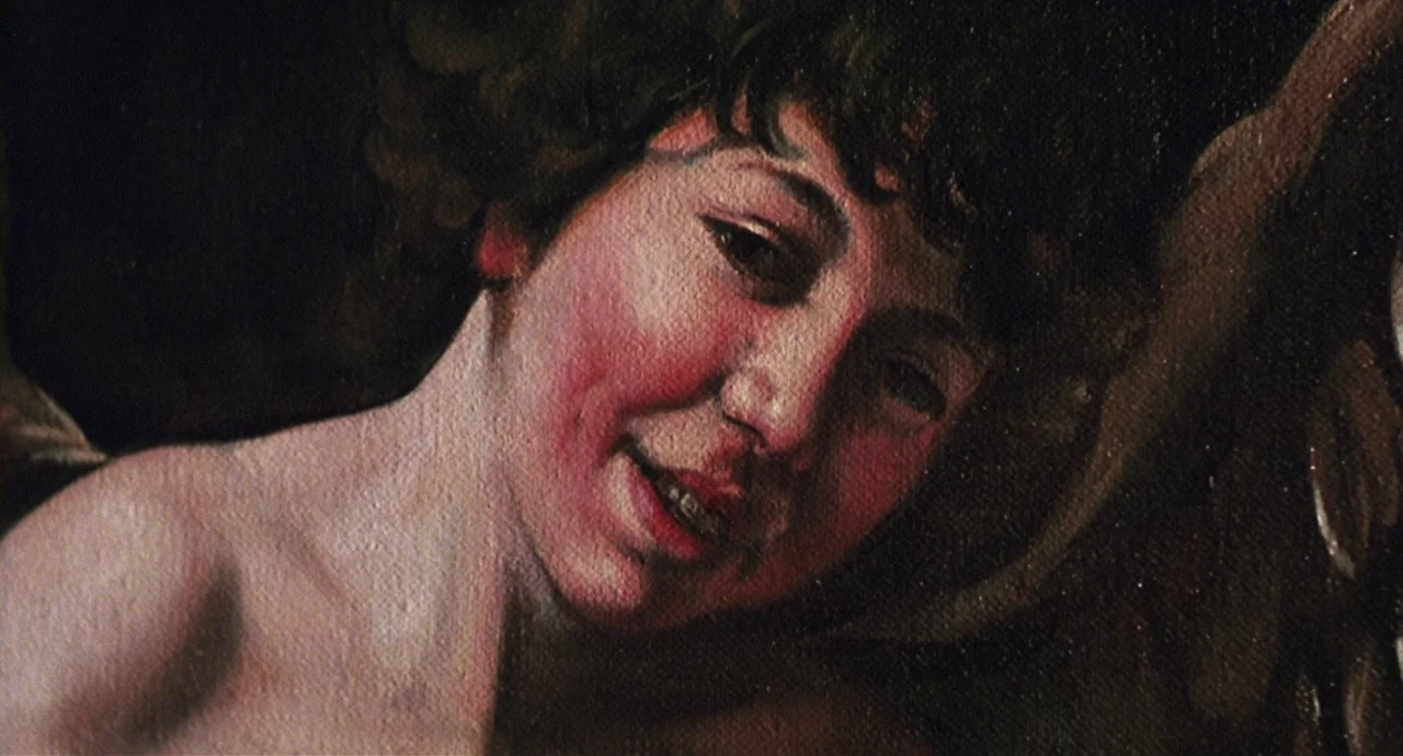 Caravaggio (1986) movie still: closeup — A close-up photograph of an oil painting on canvas showing a young person. The brushwork and texture of the…