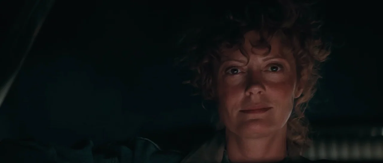 Thelma & Louise (1991) movie still: closeup — A dark vehicle interior with the subject centered against an unlit environment. The woman faces the…