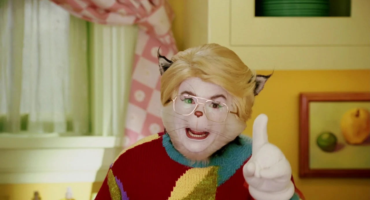 The Cat In The Hat (2003) movie still: medium — A brightly colored, stylized domestic space with yellow walls and pink checkered curtains. A…