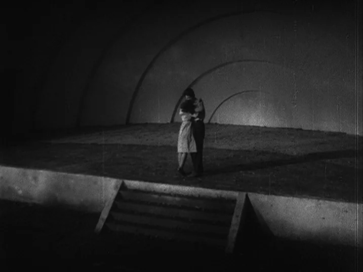 One Wonderful Sunday (1947) movie still: wide — A minimalist outdoor band shell features concentric curved wall panels and stone steps. A couple…