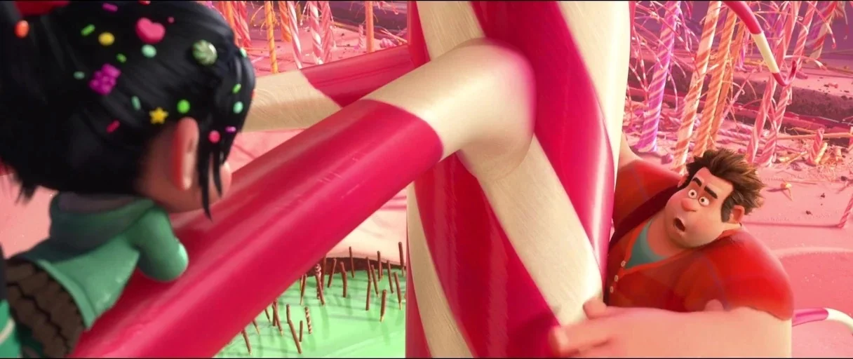 Wreck-It Ralph (2012) movie still: medium — A landscape constructed entirely of oversized colorful candies and sweets under bright daylight. A young…