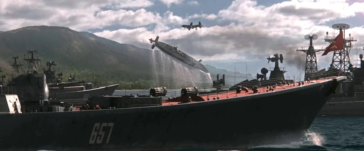 X-men (2000) movie still: wide — A fleet of large grey warships maneuvers in coastal waters near a mountain range. A submarine leaps out of the…