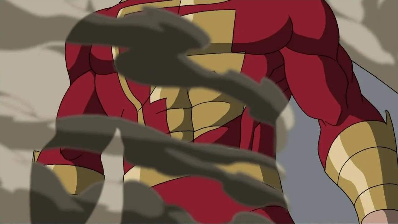 Superman/Batman: Public Enemies (2009) movie still: medium — A muscular figure in a red suit stands outdoors enveloped by thick dust clouds. The…