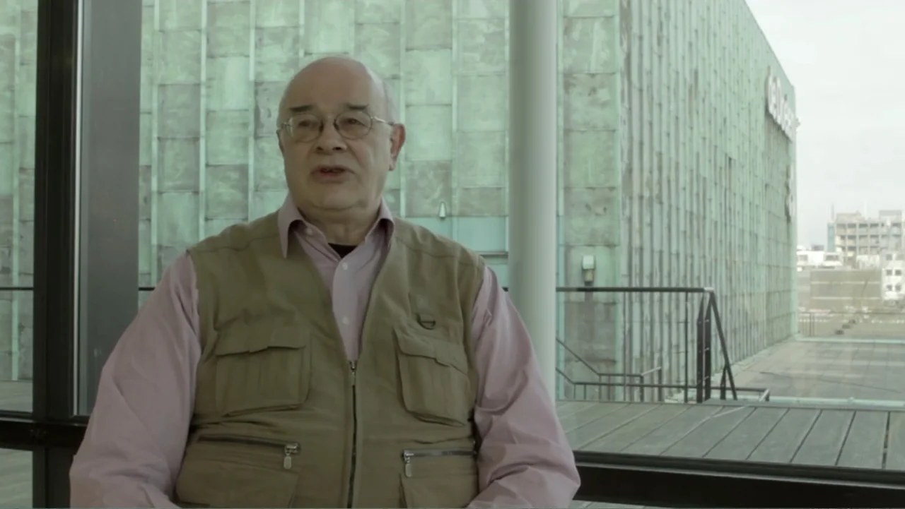 Flowers of Taipei: Taiwan New Cinema (2014) movie still: medium — A man sits on a balcony with a modern building in the background. The man speaks…
