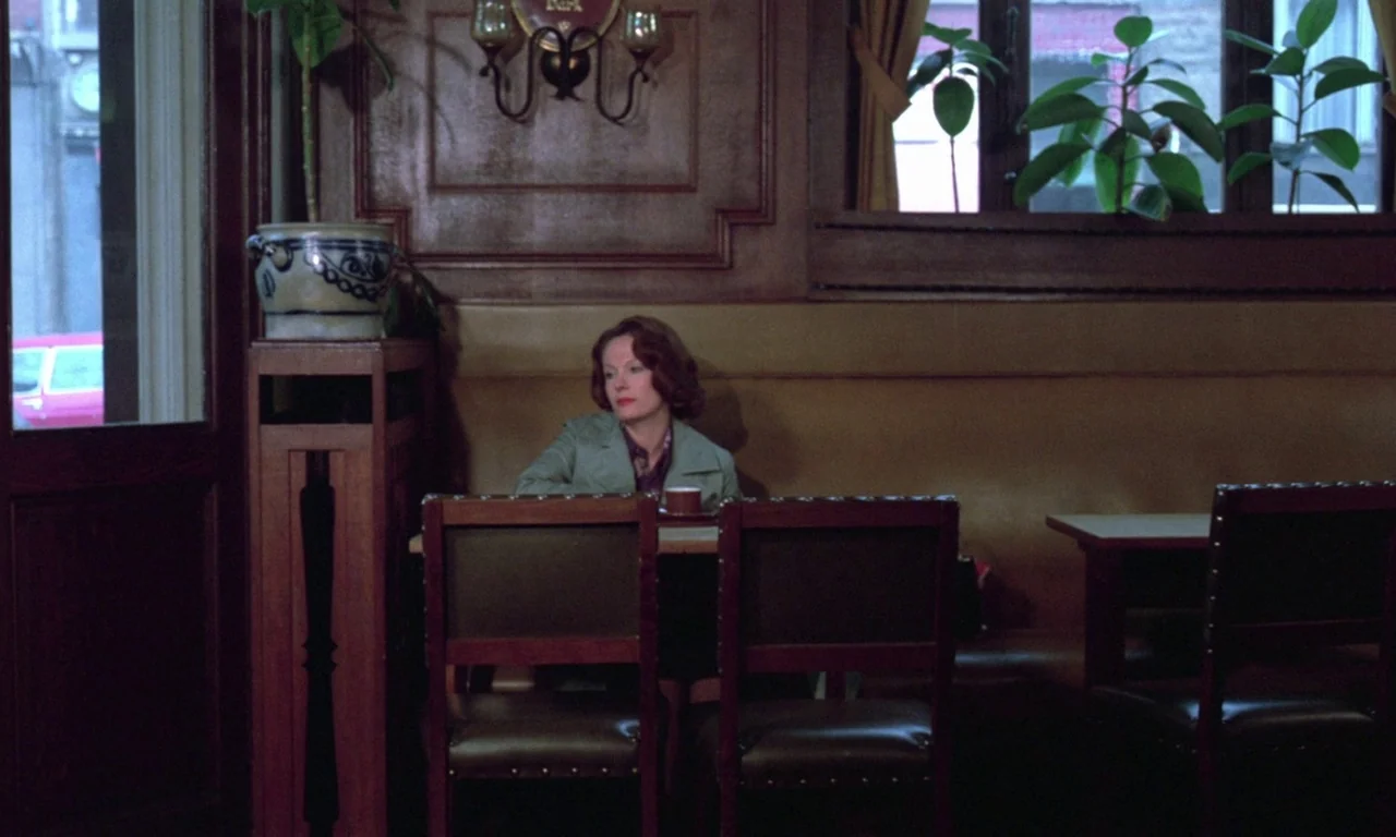 Jeanne Dielman, 23, quai du commerce, 1080 Bruxelles (1975) movie still: medium — A vintage cafe features dark wood paneling, leather booths, and…