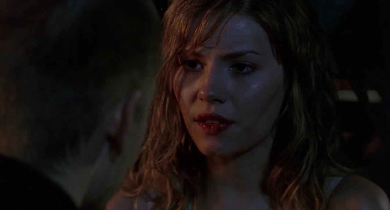 House of Wax (2005) movie still: closeup — A dark, dimly lit car interior at night with minimal ambient light. A young woman with wavy hair gazes…
