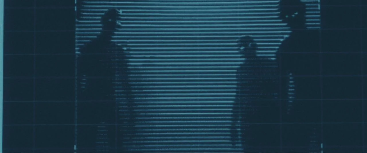Come True (2020) movie still: medium — A digital screen displays low-resolution silhouettes of three figures standing before horizontal blinds. The…