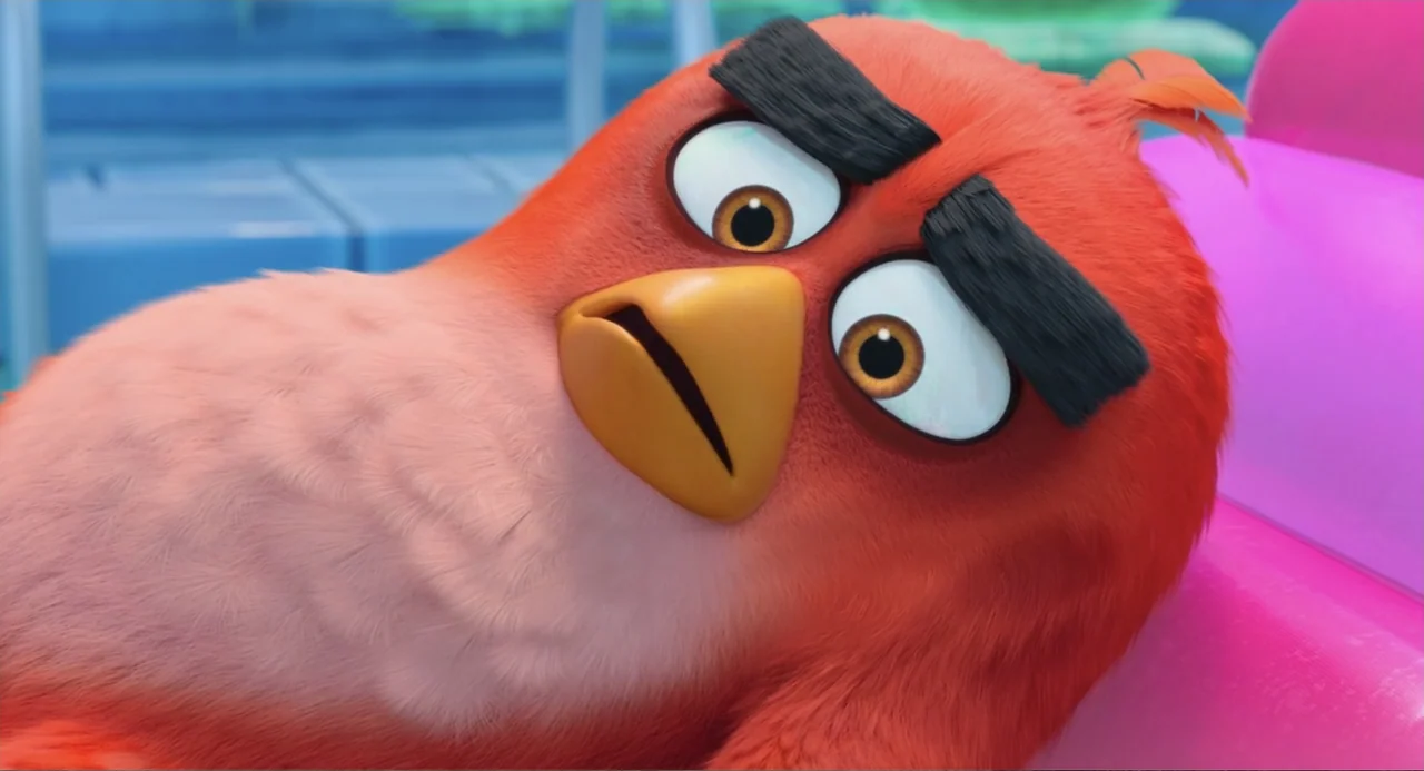 The Angry Birds Movie 2 (2019) movie still: closeup — The interior of a brightly colored room serves as the setting. A red bird with thick eyebrows…