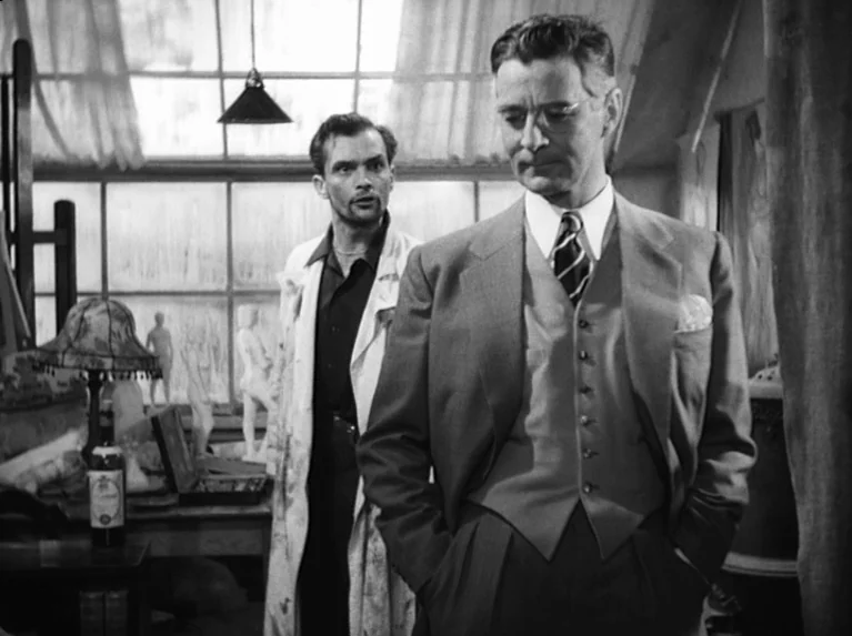 Waiting Women (1952) movie still: medium — An artist studio features large multi-pane windows and scattered sculptures in the background. A man in a…