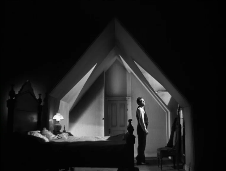 The Night Of The Hunter (1955) movie still: wide — A high-ceilinged attic bedroom features sloped walls and a prominent gabled wooden frame…