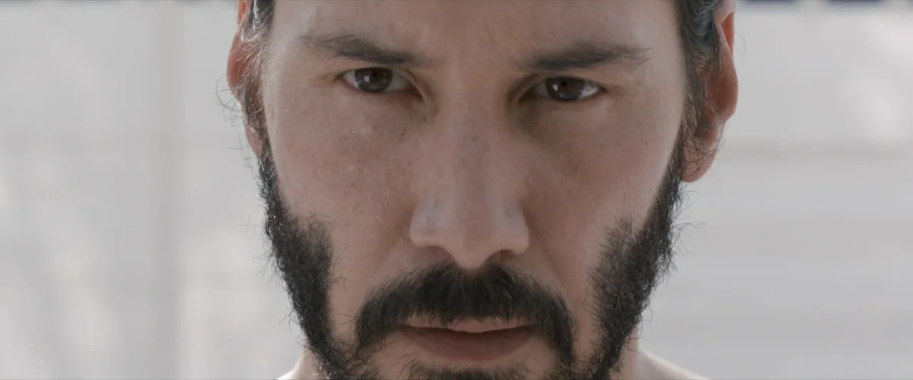 47 Ronin (2013) movie still: closeup — A featureless, brightly lit white background frames a man's face. The subject gazes directly forward into the…