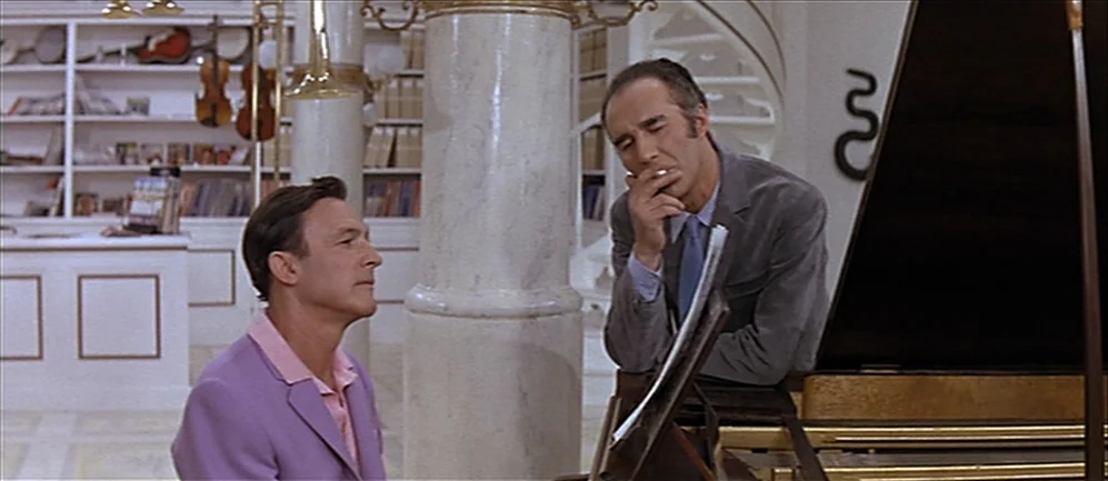 Les Demoiselles de Rochefort (1967) movie still: medium — A well-lit music room features white marble columns and white shelving filled with…