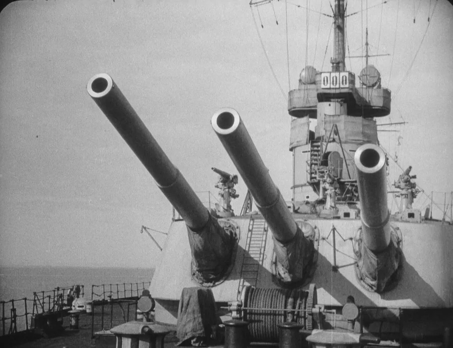 Battleship Potemkin (1925) movie still: wide — A metal battleship turret features three large artillery cannons raised toward the sky. The deck area…