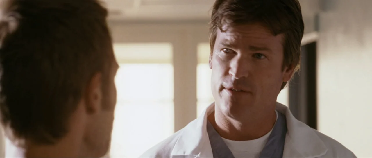 Monster-in-Law (2005) movie still: medium — An interior hospital corridor features a bright window in the blurred background. A man wearing a white…