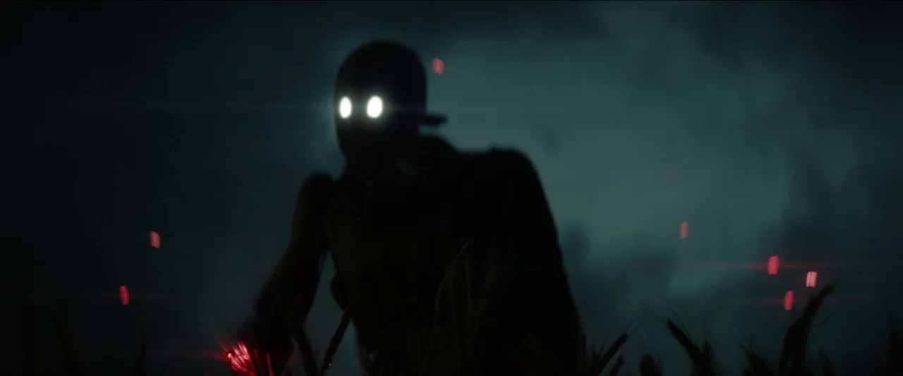 Rebel Moon – Part One: A Child of Fire (2023) movie still: medium — A field at night is bathed in deep teal and blue shadows. A dark, featureless…