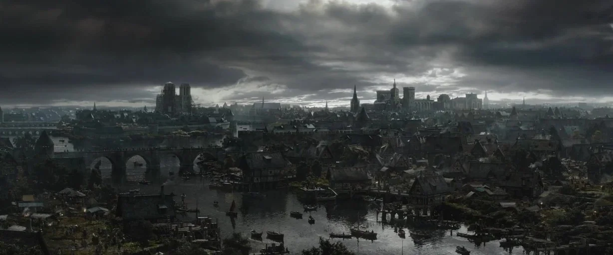 The Last Duel (2021) movie still: establishing — An sprawling medieval city sits along a river under a dense, cloudy sky. Multiple stone bridges…