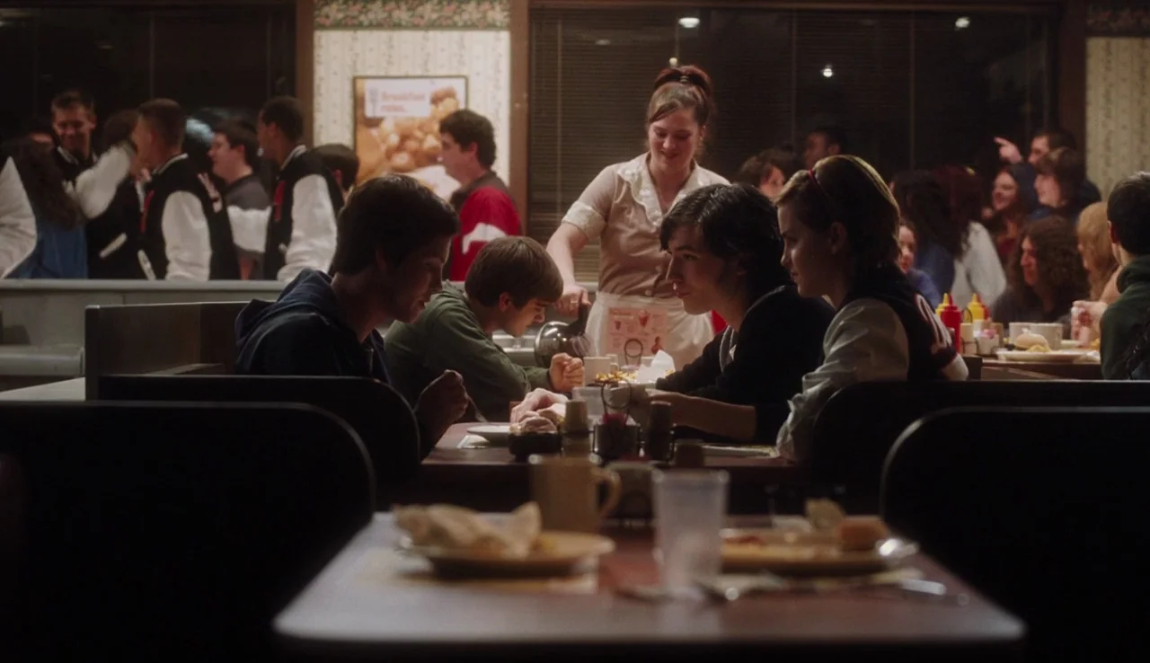 The Perks of Being A Wallflower (2012) movie still: medium — A crowded diner interior with brown vinyl booths and patterned wallpaper during…