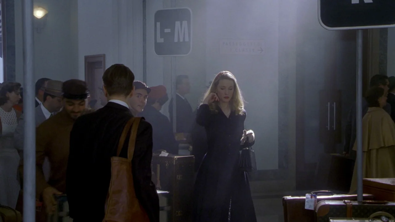 The Talented Mr. Ripley (1999) movie still: medium — A busy, smoke-filled train station terminal features signage for passengers in Italian. A…